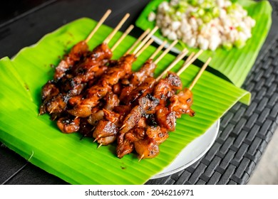 Pork Barbecue and Kinilaw na Scallops placed on banana leaves. Filipino appetizer dishes usually matched with beer. - Shutterstock ID 2046216971