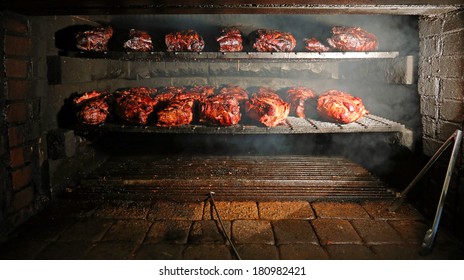 Pork Being Barbequed In A Southern Style Pit Over Hickory Wood.