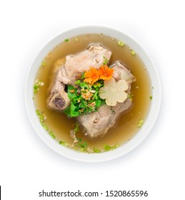 Pork Bone In Clear Soup Popular Stock Topped With Celery Cutlet . Asian Food Fusion Style Decorate Carved Carrot And Turnip Top View