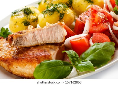 Pork chop, boiled potatoes and vegetables