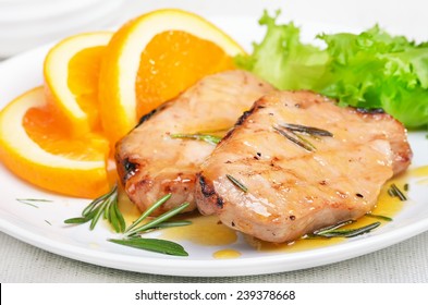 Pork Chop With Orange Sauce And Rosemary, Close Up View