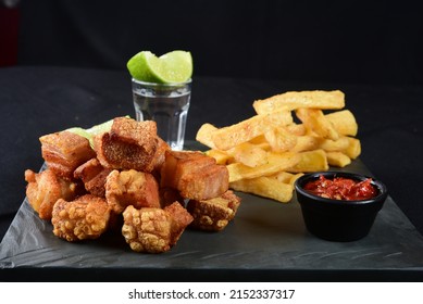pork cracklings with fried cassava and lemon pork bacon - Shutterstock ID 2152337317