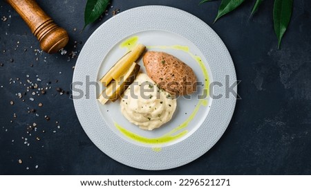 Pork cutlet with potato puree and vegetables. Fried cutlet with pickled cucumbers and mashed potatoes. Top view.