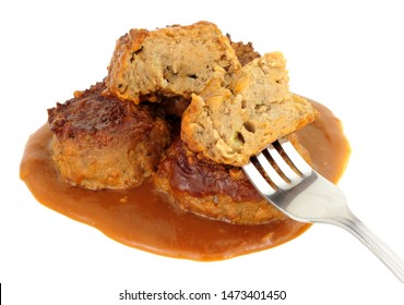 Pork faggots and gravy isolated on a white background