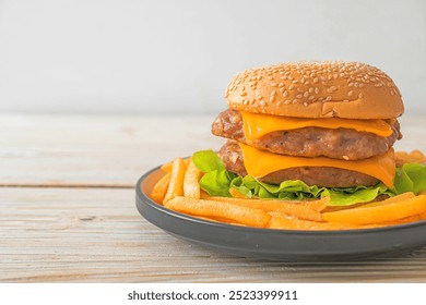 pork hamburger or pork burger with cheese and french fries - Powered by Shutterstock