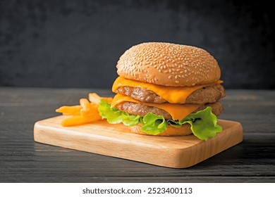 pork hamburger or pork burger with cheese and french fries - Powered by Shutterstock