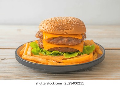 pork hamburger or pork burger with cheese and french fries - Powered by Shutterstock