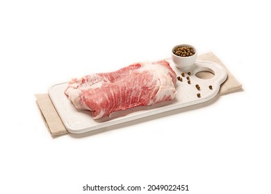 pork jowl cut over a white dish close-up. isolated white background 