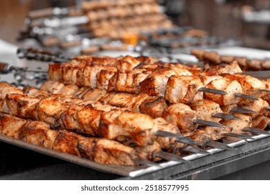 Pork kebab (shish kebab) in close-up. Meat fried on fire (barbecue) on skewers on the market counter. Delicious and mouth-watering shashlik