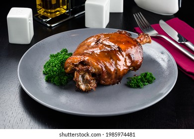 pork knuckle baked in bavarian style, Roasted pork knuckle. Tender and juicy pork wrapped in crispy, garlicky skin. Octoberfest party dinner. Festive table with delicious food, Unhealthy - Shutterstock ID 1985974481