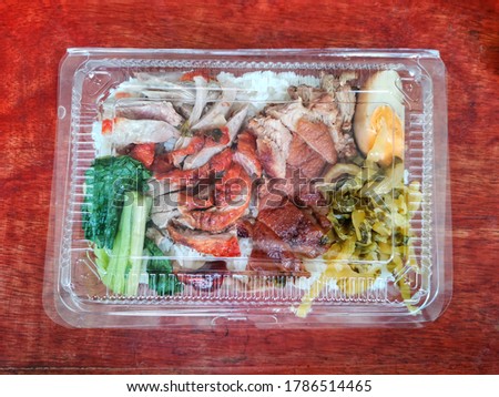 Pork leg in rice in plastic box