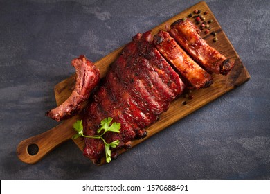 Pork loin ribs served on chopping board. View from above, top