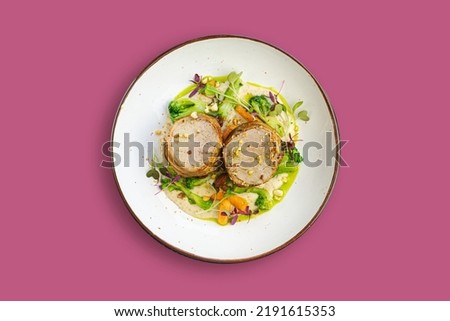 pork medallions with vegetables on a plate