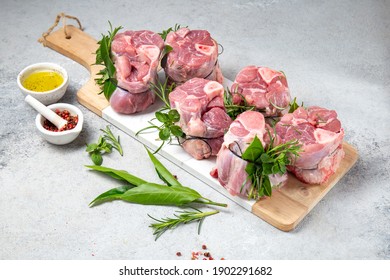 Pork Osso Buco, Shin Pork Shanks With Fresh Aromatic Herbs On White Marmol Board