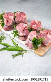 Pork Osso Buco, Shin Pork Shanks With Fresh Aromatic Herbs On White Marmol Board