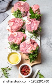 Pork Osso Buco, Shin Pork Shanks With Fresh Aromatic Herbs On White Marmol Board