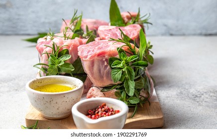 Pork Osso Buco, Shin Pork Shanks With Fresh Aromatic Herbs On White Marmol Board