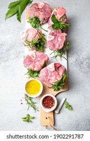 Pork Osso Buco, Shin Pork Shanks With Fresh Aromatic Herbs On White Marmol Board