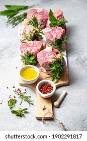 Pork Osso Buco, Shin Pork Shanks With Fresh Aromatic Herbs On White Marmol Board