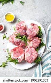 Pork Osso Buco, Shin Pork Shanks With Fresh Aromatic Herbs On White Marmol Board