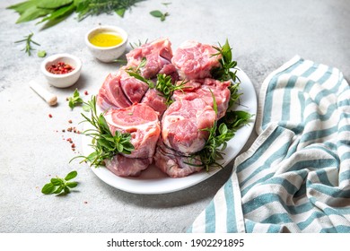 Pork Osso Buco, Shin Pork Shanks With Fresh Aromatic Herbs On White Marmol Board