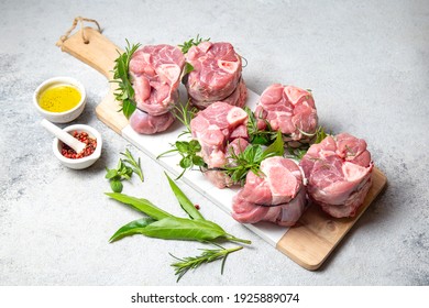 Pork Osso Buco, Shin Pork Shanks With Fresh Aromatic Herbs On White Marmol Board