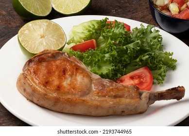 Pork Prime Rib With Tomato And Lettuce Salad On Plate