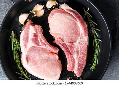 Pork Ribeye Roast In Frying Pan Grill Skillet With Herbs, Spices Close Up Grey Background