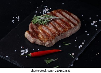 Pork Ribeye Steak. Grilled Steak On Black Background