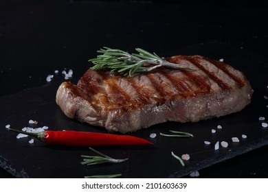 Pork Ribeye Steak. Grilled Steak On Black Background