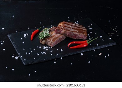 Pork Ribeye Steak. Grilled Steak On Black Background