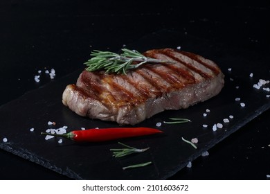 Pork Ribeye Steak. Grilled Steak On Black Background