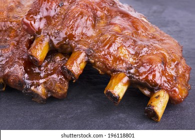 Pork Ribs Back On Slate Plate. Close Up.