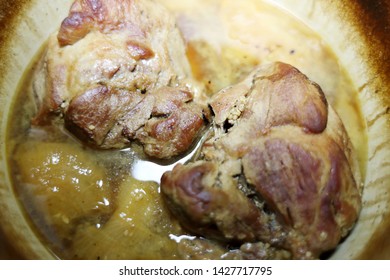 Pork Roast Cooked In A Dutch Oven Resting On The Stove Top.