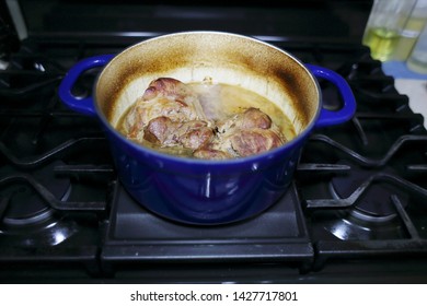 Pork Roast Cooked In A Dutch Oven Resting On The Stove Top.