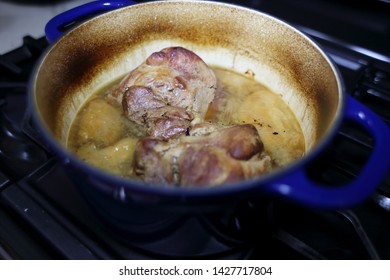 Pork Roast Cooked In A Dutch Oven Resting On The Stove Top.