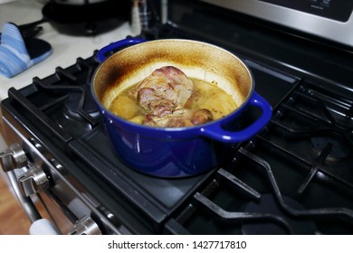 Pork Roast Cooked In A Dutch Oven Resting On The Stove Top.