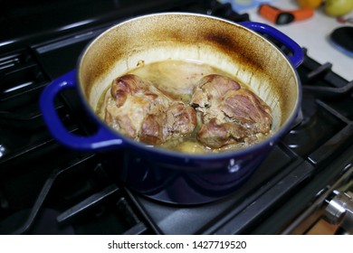 Pork Roast Cooked In A Dutch Oven Resting On The Stove Top.