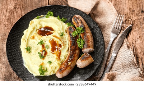 pork sausages in sauce with mashed potatoes, real photo