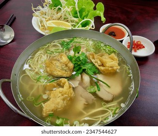 Pork and seafood with rice vermicelli noodles soup, Vietnamese food  - Powered by Shutterstock