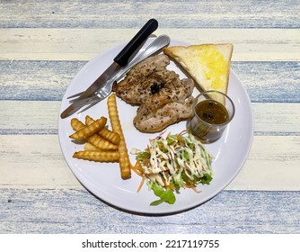 Pork Steak With Black Pepper Sauce Served With Garlic Bread, French Fried And Salad