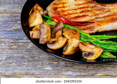 Pork steak with vegetables and mashrooms - Shutterstock ID 1043395234