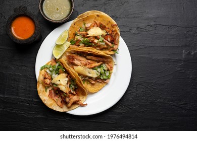 Pork tacos called al pastor with pineapple on dark background. Traditional mexican tacos - Shutterstock ID 1976494814