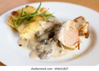 Pork Tenderloin In Bacon With Potatoes And Mushroom Sauce