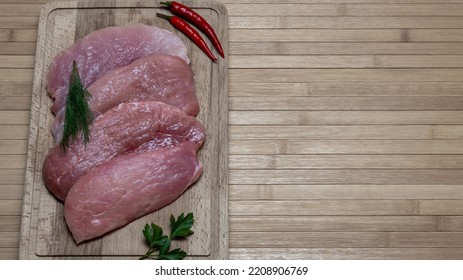 Pork tenderloin on a cutting board. Space for printing text. - Shutterstock ID 2208906769