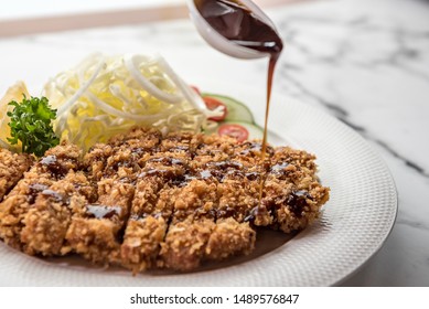 Pork tonkatsu served with lettuce And delicious gravy Is a national food that is good for health, Pork tonkatsu