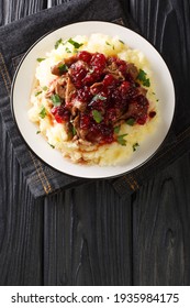 Poronkaristys Sauteed Reindeer, Mashed Potatoes And Lingonberries Close-up In A Plate On The Table. Vertical Top View Above
