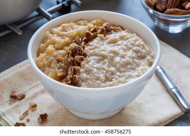 Porridge Bowl With Spiced Apple Sauce And Pecans, Breakfast For One Person, Closeup Photo