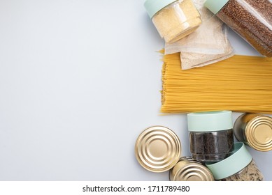 Porridge, buckwheat, canned food, tea and essentials on a blue background with place for text. Template for designer - Shutterstock ID 1711789480