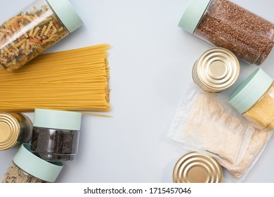 Porridge, buckwheat, canned food, tea and essentials on a blue background with place for text. Template for designer - Shutterstock ID 1715457046